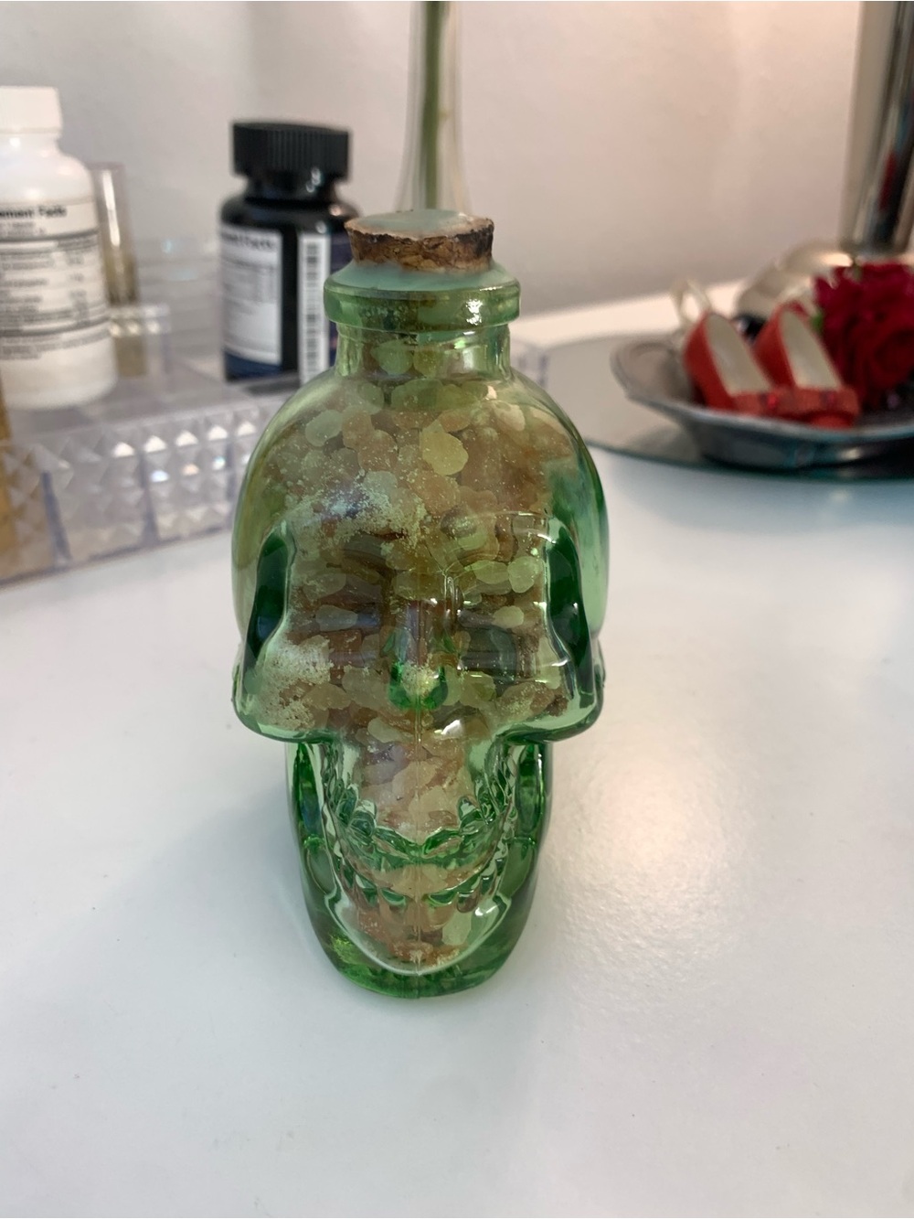 Green Glass Skull Bottle/filled W/pink salt & various crystals